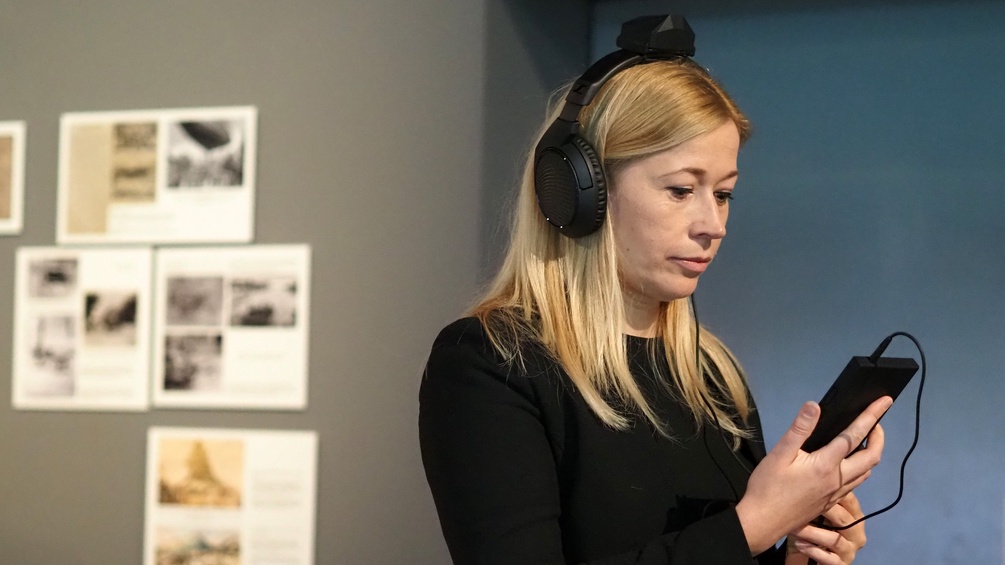 Frau hört Ausstellungsaudio, "Being Anton Bruckner" bei der Ars Electronica