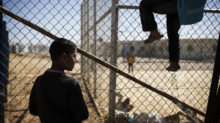 Kinder klettern am Zaun des Flüchtlingslagers Zaatari