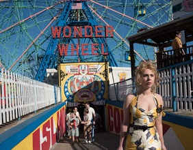 Blonde Frau in einem Sommerkleid vor dem Riesenrad