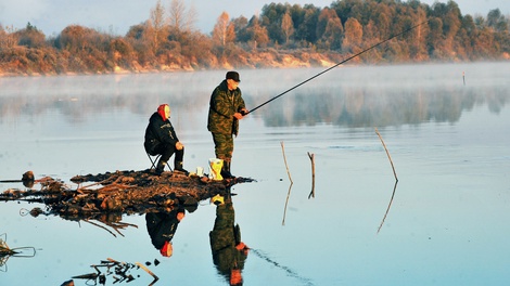 Sitzende Frau neben fischenden Mann in Yuzefovo