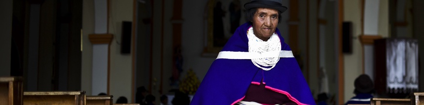 Indigene kolumbianische Frau verlässt ein Kirchengebäude