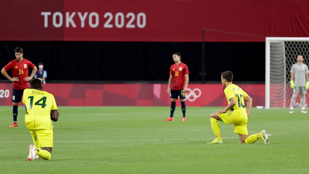 Fussballspieler gehen auf die Knie umd ein Zeichen gegen Rassismus zu setzen bei den Olympischen Spielen 2020 in Tokyo.