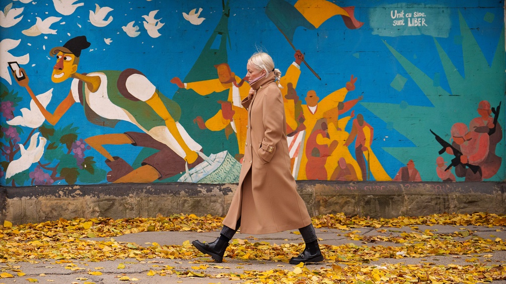 Passantin in Chisinau vor einer Graffiti-Wand