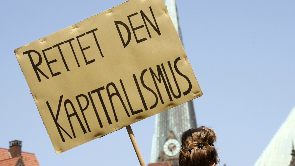 Schild mit der Aufschrift "Rettet den Kapitalismus"