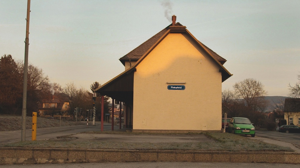 Gelbes Bahnhofsgebäude mit der Afschrift "Pinkafeld"