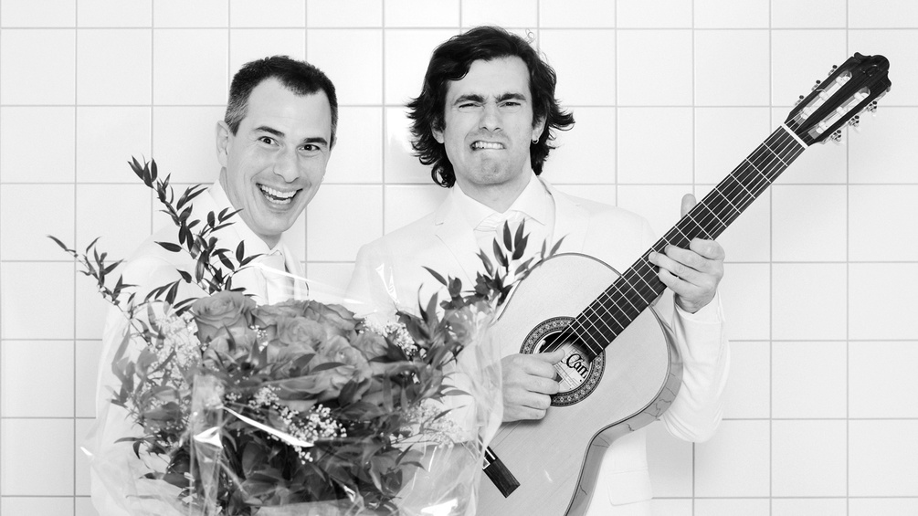 Christoph & Lollo mit Blumen und Gitarre.