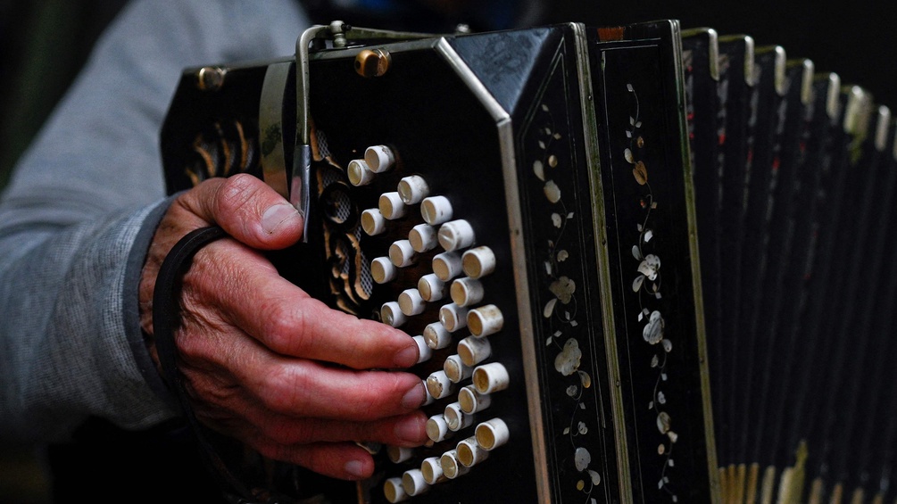 PICTUREDESK.COM/AFP/LUIS ROBAYO  Männerhand und Bandoneon