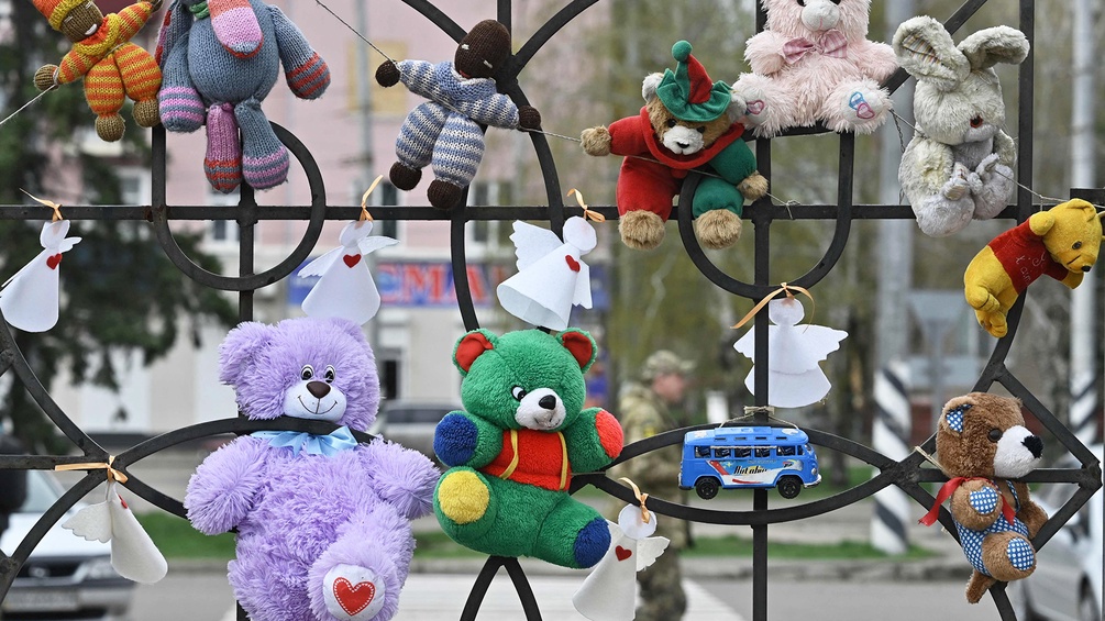 Stofftiere an einem Zaun im ukrainischen Kriegsgebiet