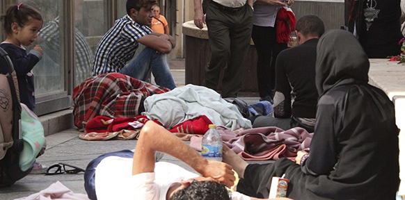 Flüchtlinge, am Boden sitzend