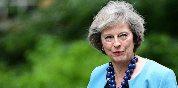 APA/AFP/LEON NEAL Theresa May
