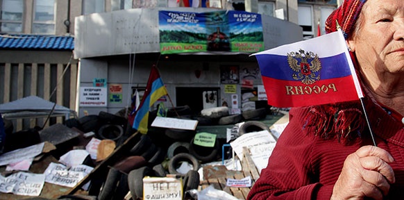 Ukrainische Frau hält russische Fahne