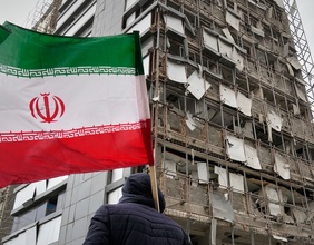 Mann hält die iranische Flagge in Teheran