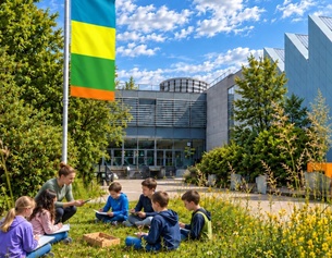 Kinder sitzen vor einem Museum
