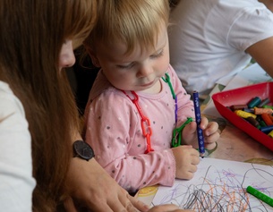 Eine Pädagogin mit Kindergartenkind.