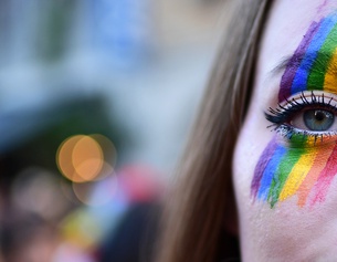 Frau mit Regenbogenschminke im Gesicht