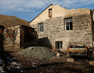 AP/EMRAH GUREL Aserbaidschanischer Soldat vor einem zerstörten Haus in Armenien